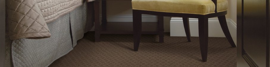 Bed and armchair on carpet from Carpet World Flooring in Canyon